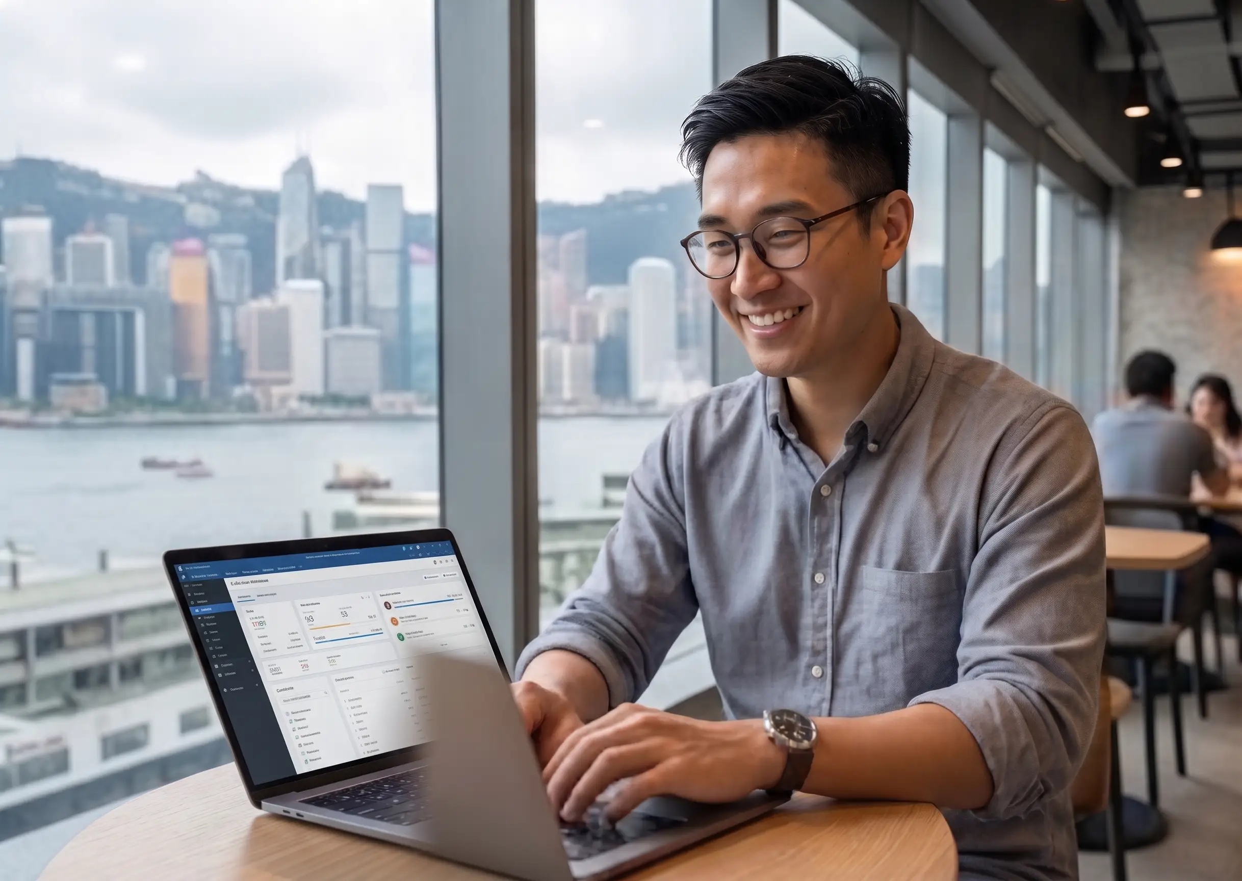 confident young male entrepreneur working in trendy cafe, laptop open, casual business attire in Hong Kong